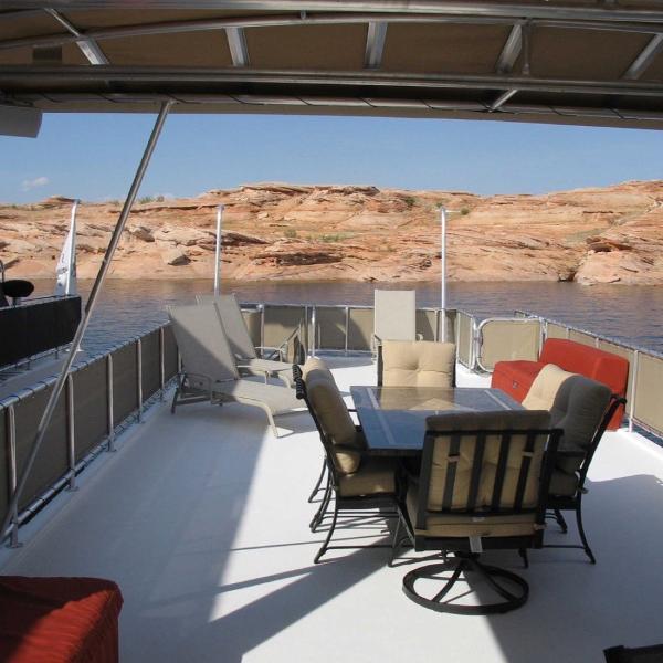 Slide: The Image of 2007 Stardust Cruisers Sundancer Trip 7 houseboat deck with seating, overlooking rocky shoreline. - 10