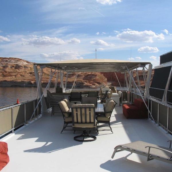 Slide: The Image of 2007 Stardust Cruisers Sundancer Trip 7 houseboat deck with seating, under a clear blue sky. - 11