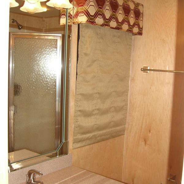 Slide: The Image of Bathroom interior of 2007 Stardust Cruisers Sundancer Trip 7, featuring shower and mirror. - 6