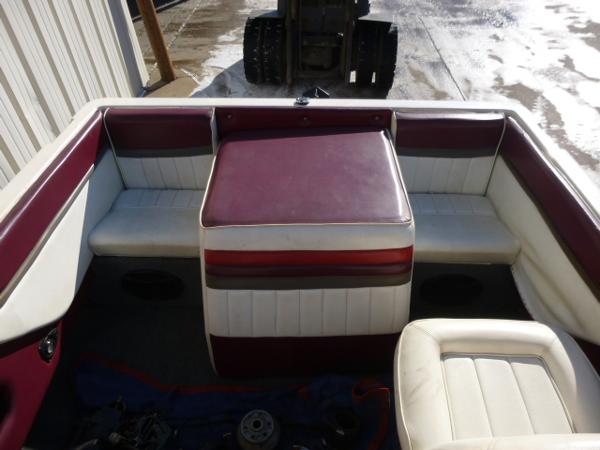 Slide: The Image of 1990 Sunbird CORSICA 188 Cuddy Cabin boat interior with red and white seating. - 10