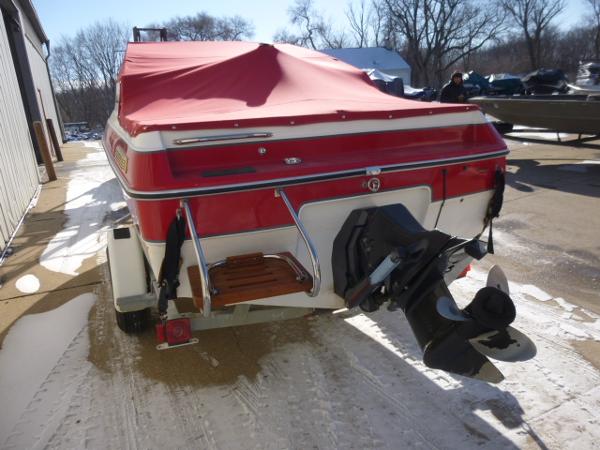 Slide: The Image of 1990 Sunbird CORSICA 188 Cuddy Cabin boat with red cover, rear view. - 4