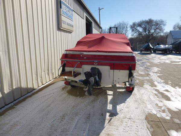 Slide: The Image of 1990 Sunbird CORSICA 188 Cuddy Cabin boat with red cover in outdoor storage. - 5
