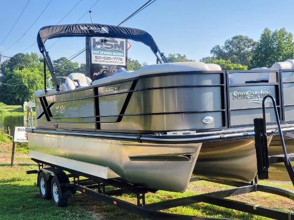 Slide: The Image of 2023 SunCatcher Fusion 322RC pontoon boat on trailer, displayed outdoors. - 1
