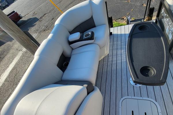Slide: The Image of 2023 SunCatcher Fusion 322RC boat interior with cushioned seating and cup holders. - 13