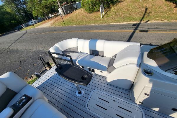 Slide: The Image of 2023 SunCatcher Fusion 322RC boat interior with white seating and table. - 8