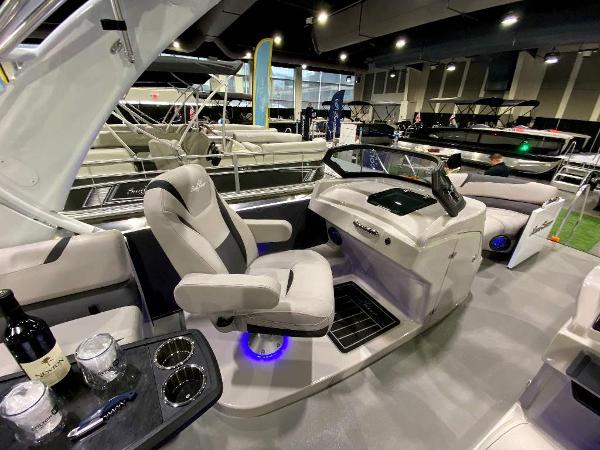 Slide: The Image of 2024 SunChaser Calais 23 SB DC boat interior with captain's chair and control console. - 10