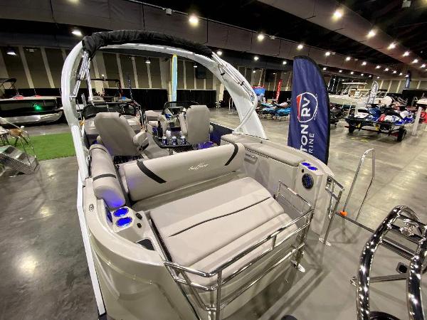 Slide: The Image of 2024 SunChaser Calais 23 SB DC pontoon boat on display at a boat show. - 18