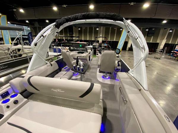 Slide: The Image of 2024 SunChaser Calais 23 SB DC pontoon boat interior with modern seating and blue LED lighting. - 7