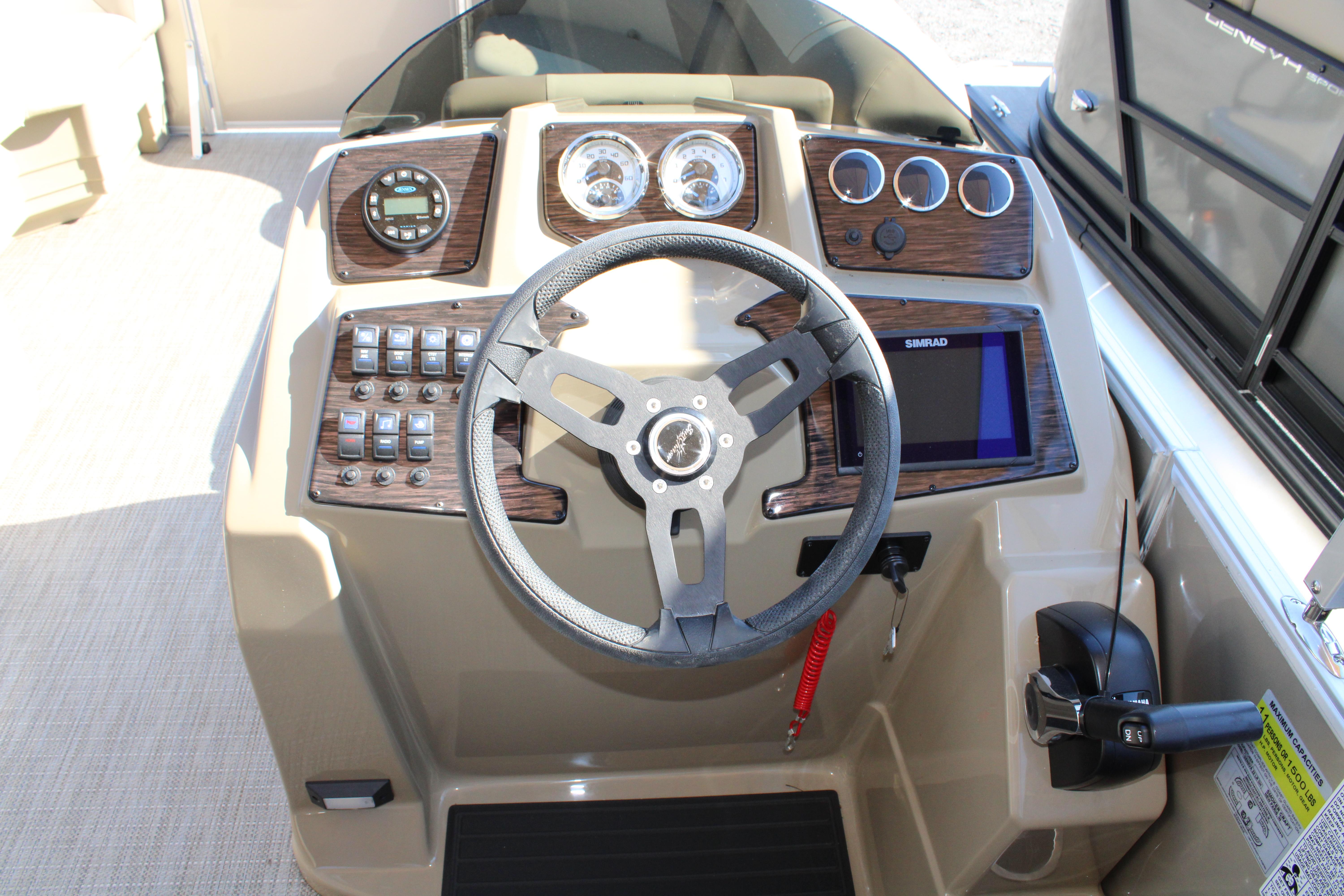 Slide: The Image of 2023 SunChaser Geneva Cruise 22 LR DH boat dashboard with steering wheel and control panel. - 11