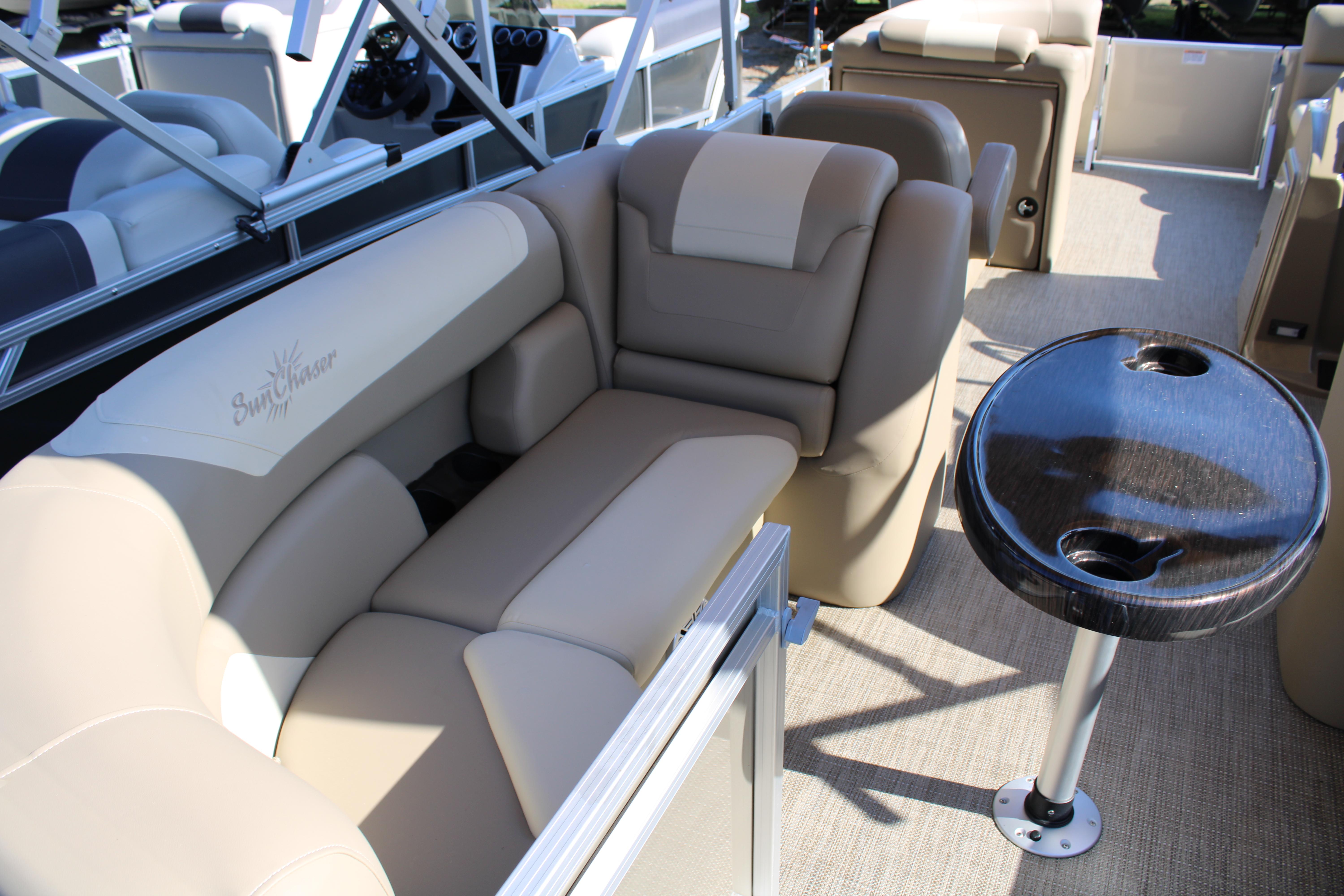 Slide: The Image of 2023 SunChaser Geneva Cruise 22 LR DH pontoon boat interior with beige seating and table. - 9