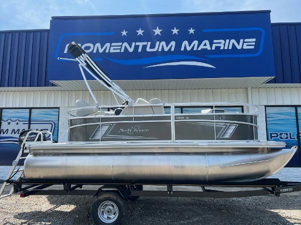 Slide: The Image of 2023 SunChaser Vista 16 Fish pontoon boat on trailer at Momentum Marine dealership. - 0