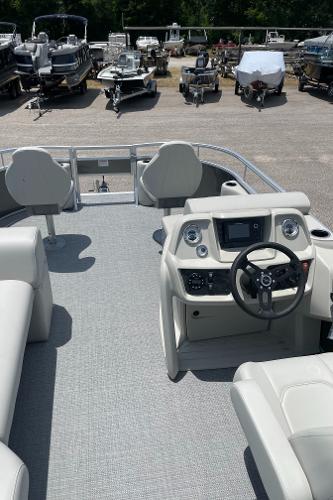 Slide: The Image of 2023 SunChaser Vista 16 Fish pontoon boat interior with steering console and seating. - 8