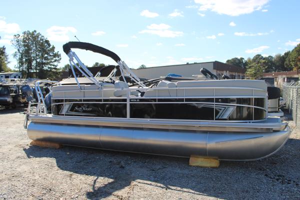 Slide: The Image of 2024 SunChaser Vista 22 LR pontoon boat on gravel lot. - 1