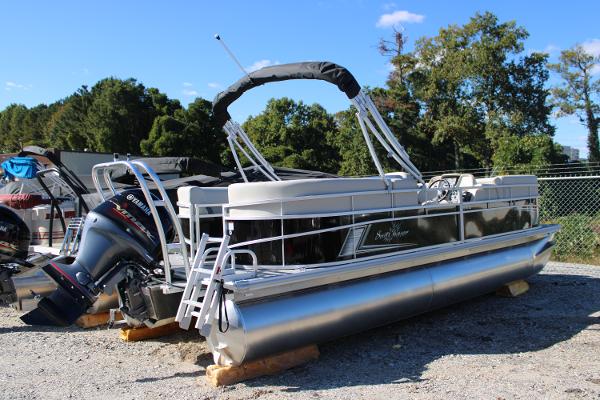 Slide: The Image of 2024 SunChaser Vista 22 LR pontoon boat on display outdoors. - 2