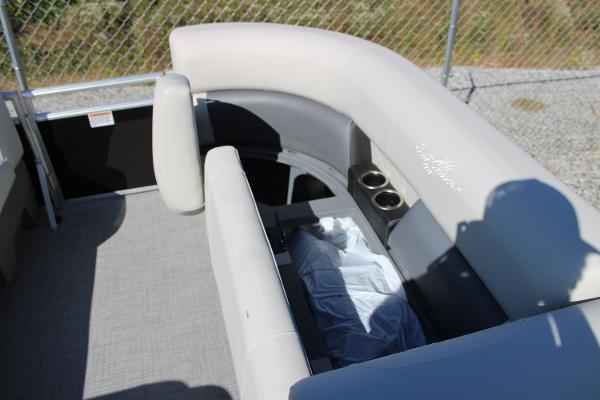 Slide: The Image of 2024 SunChaser Vista 22 LR boat interior with cushioned seating and cup holders. - 5