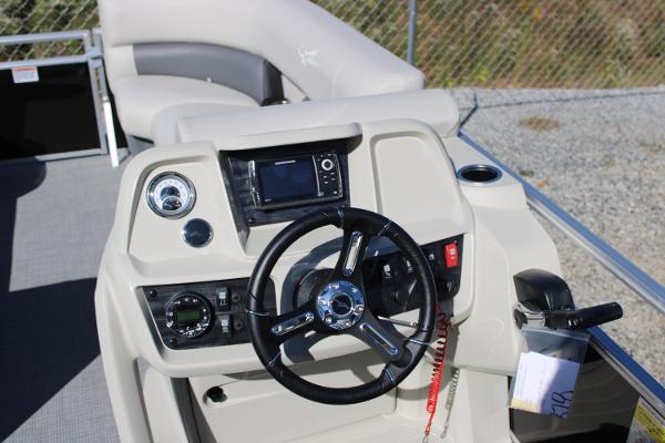 Slide: The Image of 2024 SunChaser Vista 22 LR boat dashboard with steering wheel and control panel. - 8