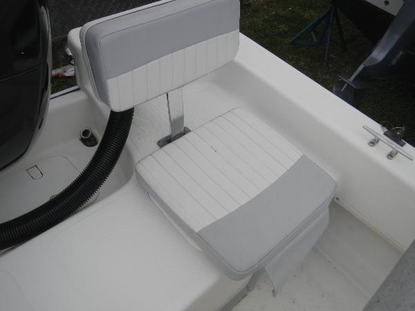Slide: The Image of 2016 Sundance 17 Center Console boat seat with white and gray upholstery. - 11