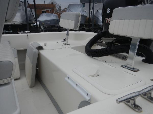 Slide: The Image of 2016 Sundance 17 Center Console boat interior with seating and motor. - 15
