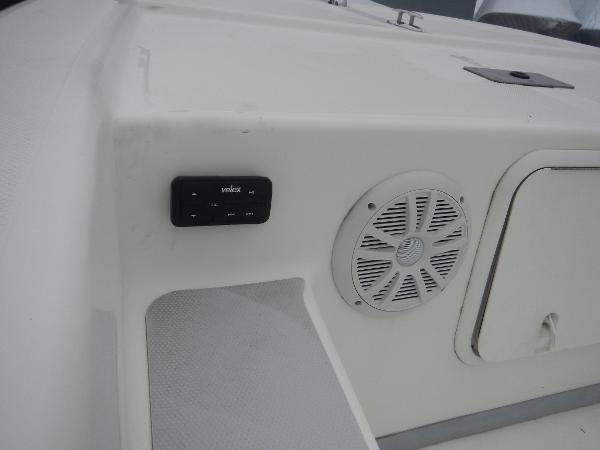 Slide: The Image of 2016 Sundance 17 Center Console boat interior with speaker and control panel. - 16