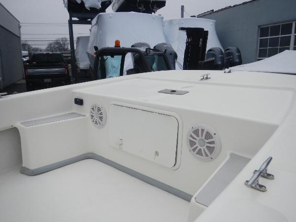 Slide: The Image of 2016 Sundance 17 Center Console boat interior with storage and speakers. - 18