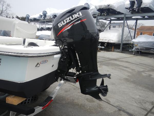 Slide: The Image of 2016 Sundance 17 Center Console boat with Suzuki outboard motor in storage facility. - 23