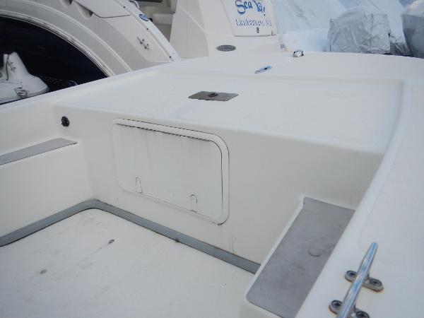Slide: The Image of 2016 Sundance 17 Center Console boat interior, white deck with storage compartment. - 4