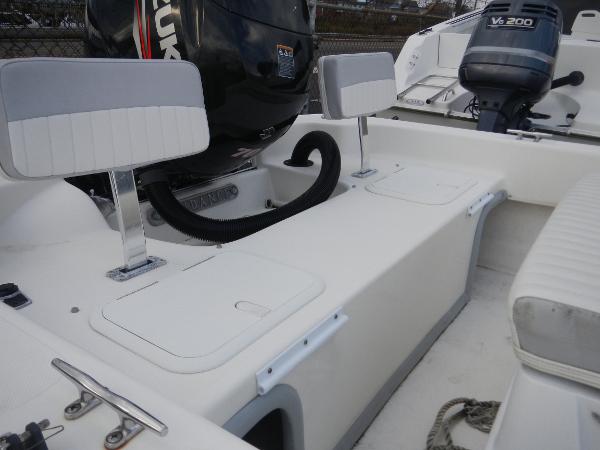Slide: The Image of 2016 Sundance 17 Center Console boat interior with Suzuki and Yamaha outboard motors. - 5