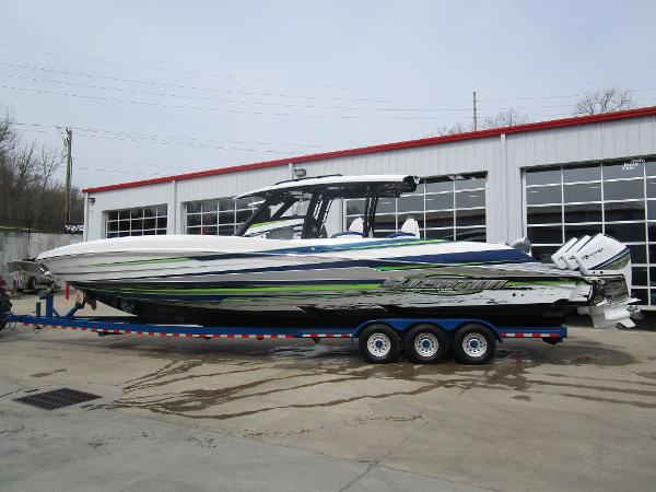 Slide: The Image of 2024 Sunsation 40CCX powerboat on a trailer outside a garage. - 1
