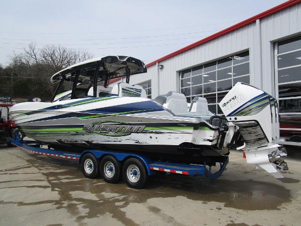 Slide: The Image of 2024 Sunsation 40CCX powerboat on a trailer outside a garage. - 2