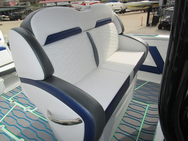 Slide: The Image of 2024 Sunsation 40CCX boat with white and blue cushioned seating. - 21