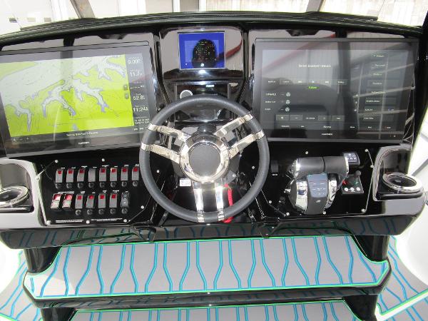 Slide: The Image of 2024 Sunsation 40CCX boat dashboard with dual screens and advanced controls. - 24