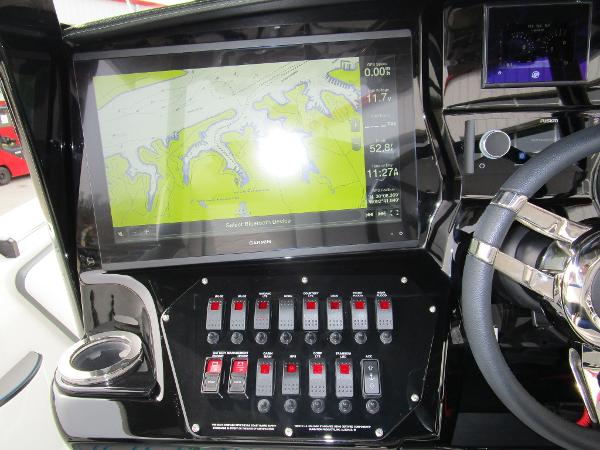 Slide: The Image of 2024 Sunsation 40CCX boat dashboard with navigation screen and control switches. - 27