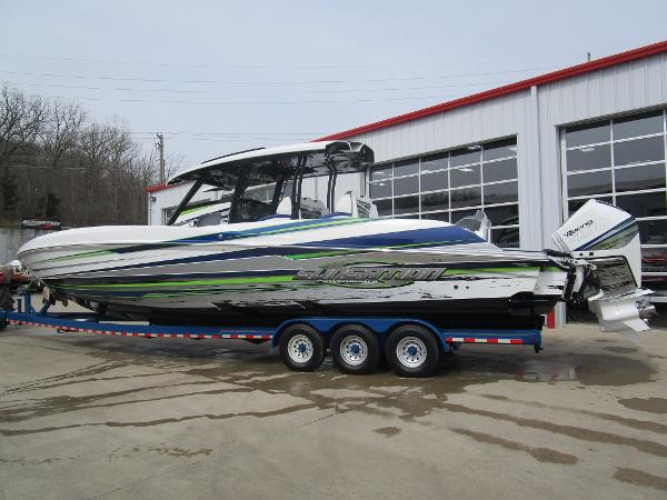 Slide: The Image of 2024 Sunsation 40CCX powerboat on a trailer outside a garage. - 3