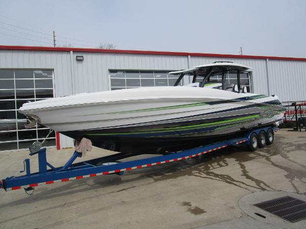 Slide: The Image of 2024 Sunsation 40CCX boat on trailer outside a warehouse. - 4
