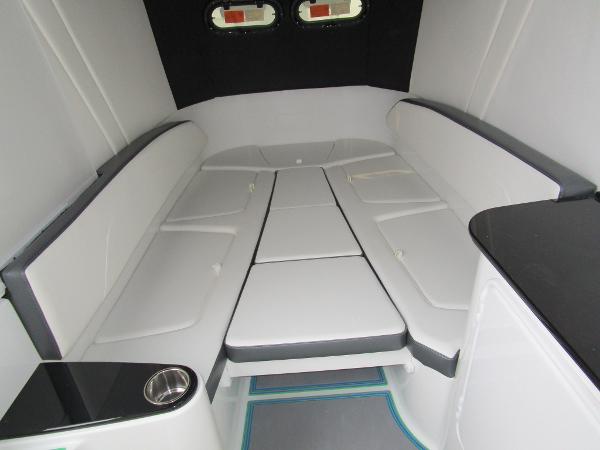 Slide: The Image of Interior cabin of 2024 Sunsation 40CCX boat with white cushioned seating. - 40