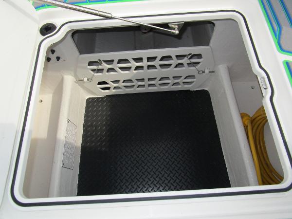 Slide: The Image of Storage compartment of 2024 Sunsation 40CCX boat with black mat and yellow cable. - 43
