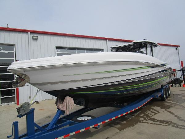 Slide: The Image of 2024 Sunsation 40CCX boat on a trailer outside a garage. - 5