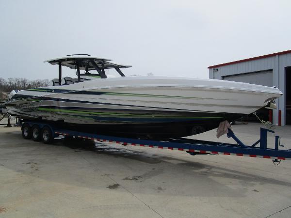 Slide: The Image of 2024 Sunsation 40CCX powerboat on a trailer outside a storage facility. - 7
