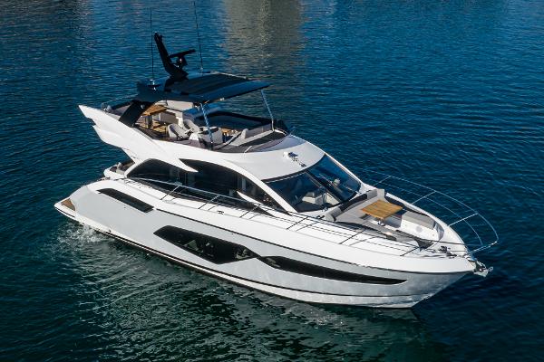 Slide: The Image of 2022 Sunseeker Manhattan 55 luxury yacht cruising on clear blue water. - 2