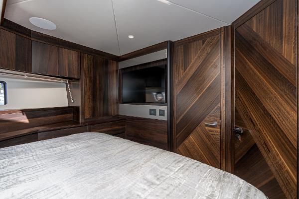 Slide: The Image of Luxurious bedroom interior of 2022 Sunseeker Manhattan 55 yacht with dark wood finish. - 32