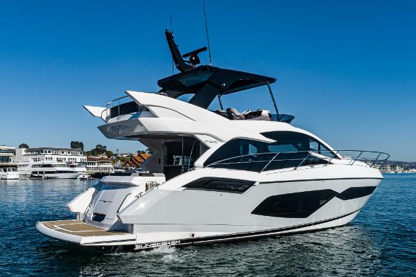 Slide: The Image of 2022 Sunseeker Manhattan 55 luxury yacht on water, side view. - 4