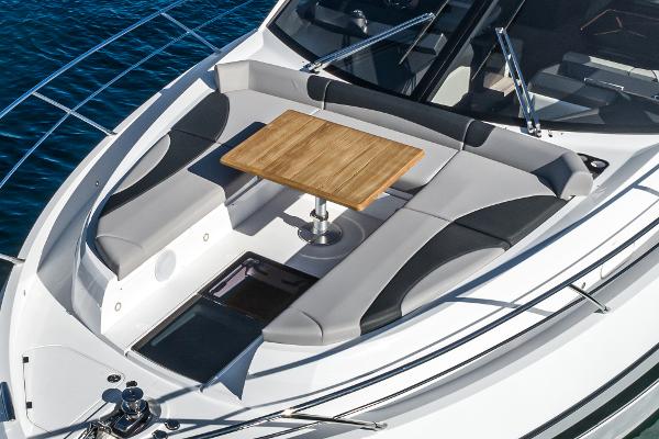 Slide: The Image of Sunseeker Manhattan 55 2022 yacht with luxurious seating and wooden table on deck. - 8
