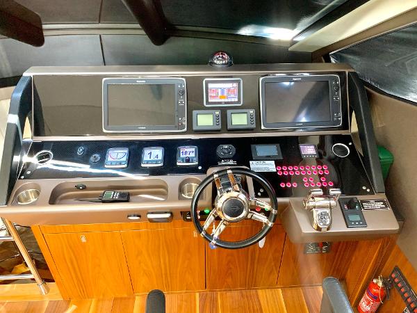 Slide: The Image of Sunseeker Manhattan 65 2016 yacht helm with advanced navigation systems and wooden cabinetry. - 10