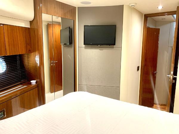 Slide: The Image of Luxurious bedroom interior of 2016 Sunseeker Manhattan 65 yacht with TV and wooden finishes. - 18