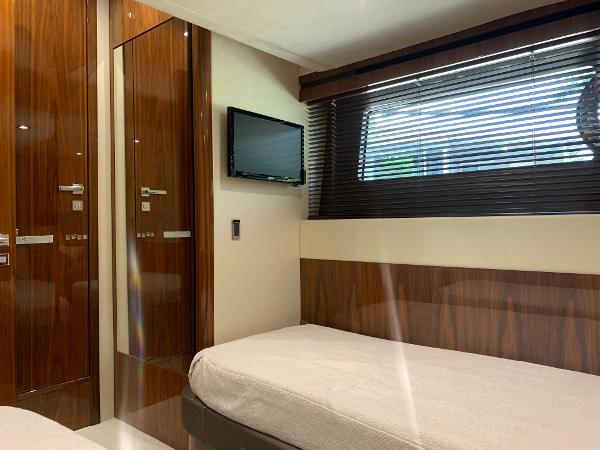 Slide: The Image of Luxurious cabin interior of 2016 Sunseeker Manhattan 65 yacht with twin beds and TV. - 21