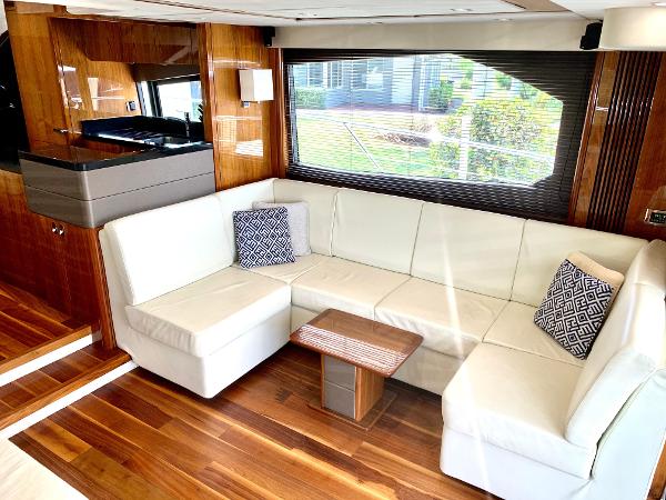 Slide: The Image of Luxurious interior of 2016 Sunseeker Manhattan 65 yacht with white leather sofa and wooden flooring. - 4