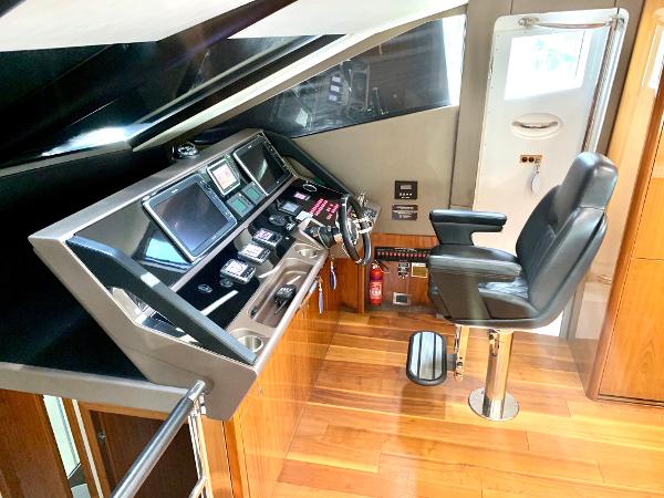 Slide: The Image of Helm station of 2016 Sunseeker Manhattan 65 yacht with modern controls and captain's chair. - 9