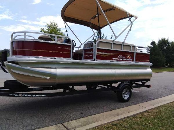 Slide: The Image of 2024 Sun Tracker Bass Buggy 18 DLX pontoon boat on a trailer. - 1