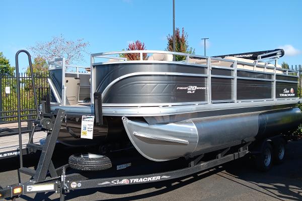 Slide: The Image of 2024 Sun Tracker Fishin' Barge 20 DLX pontoon boat on a trailer. - 1
