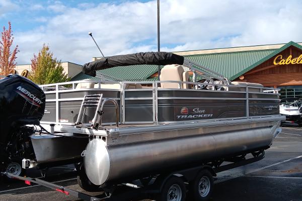 Slide: The Image of 2024 Sun Tracker Fishin' Barge 20 DLX pontoon boat parked outside Cabela's. - 3